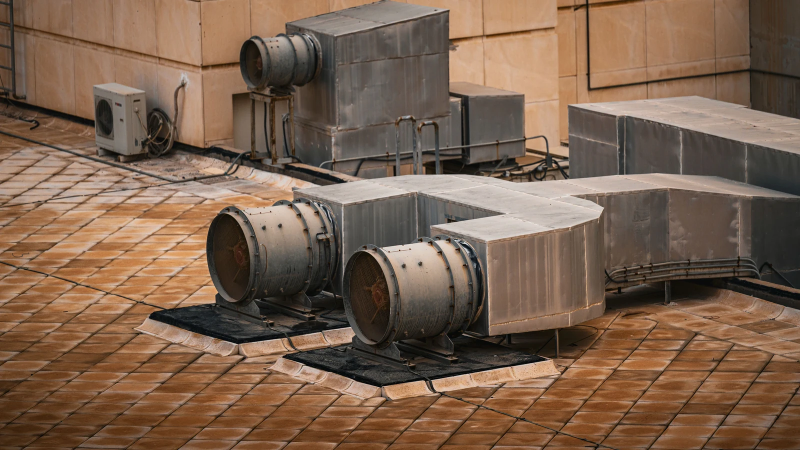 Ventilation equipment on a building rooftop, photographed by Optical Chemist for Pexels.