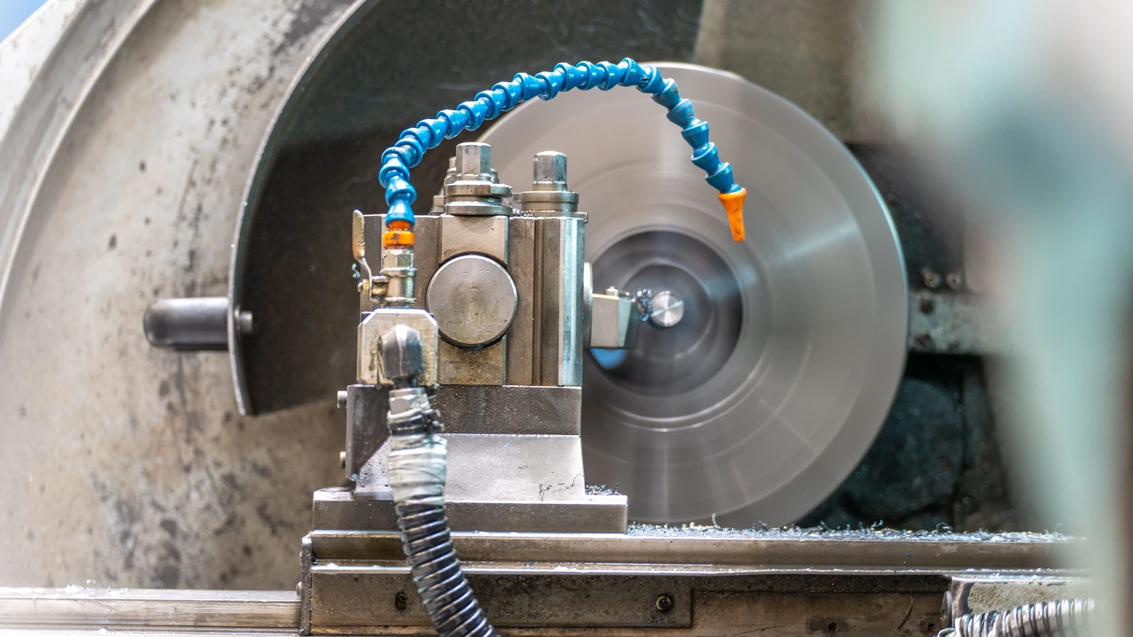 A metalworking lathe operating in a workshop, a representative industrial production photograph by Connor Lucock/Pexels.