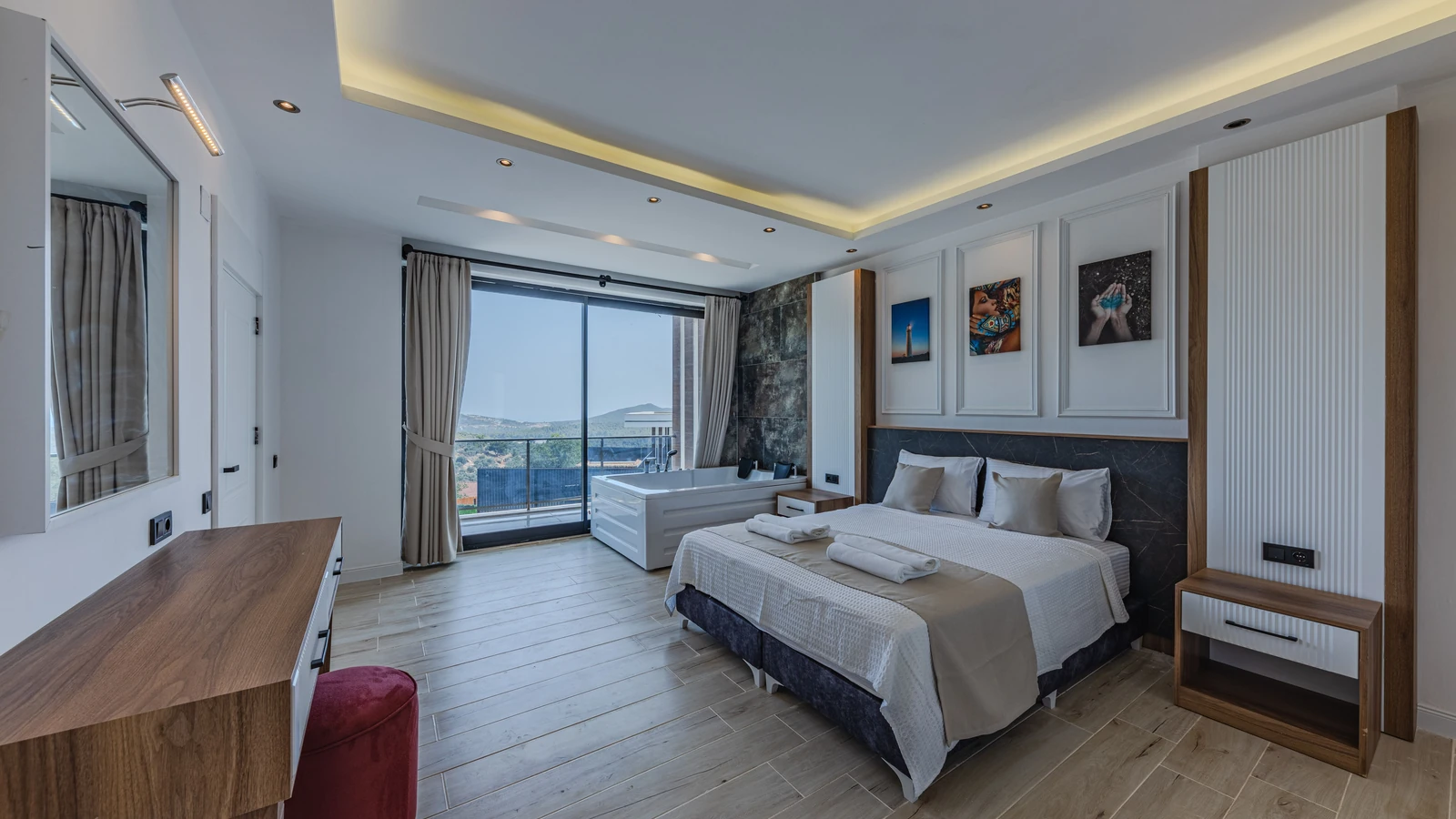 A hotel bedroom with a large bed and balcony, a representative accommodation photograph by Ahmet ÇÖTÜR from Pexels.