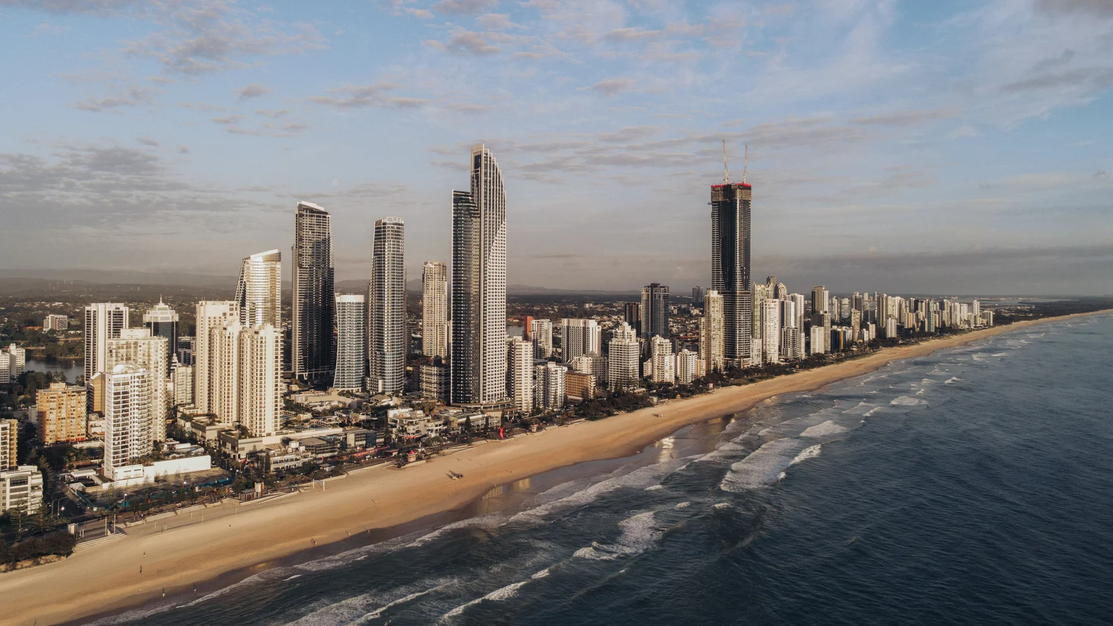 Aerial view of Gold Coast high-rises beside the beach and ocean. Photo: Parth Patel / Pexels.