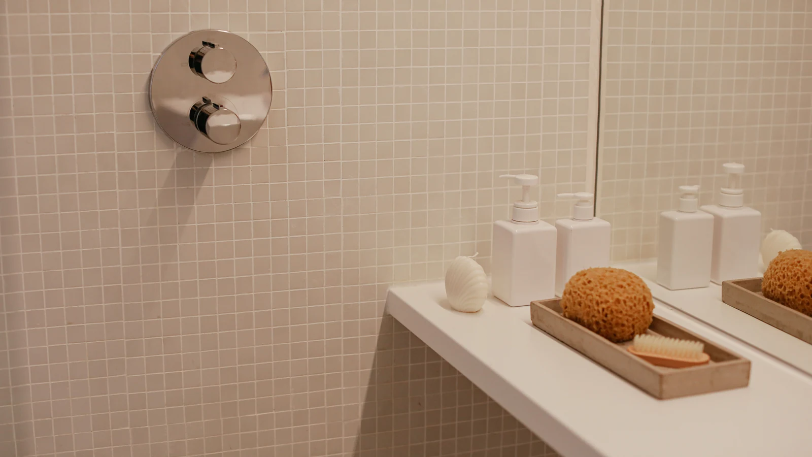 Pump bottles and a sponge sit on a bathroom shelf, a representative stock photograph by Cup of Couple via Pexels.
