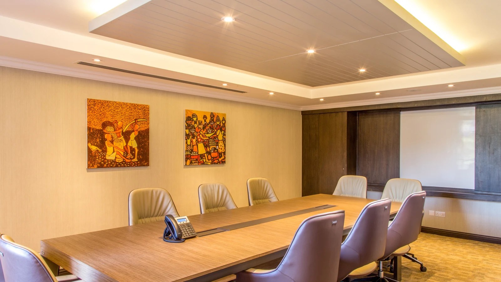 An empty conference room with a long table and office chairs, shown in a representative photograph by Skills Media for Pexels.