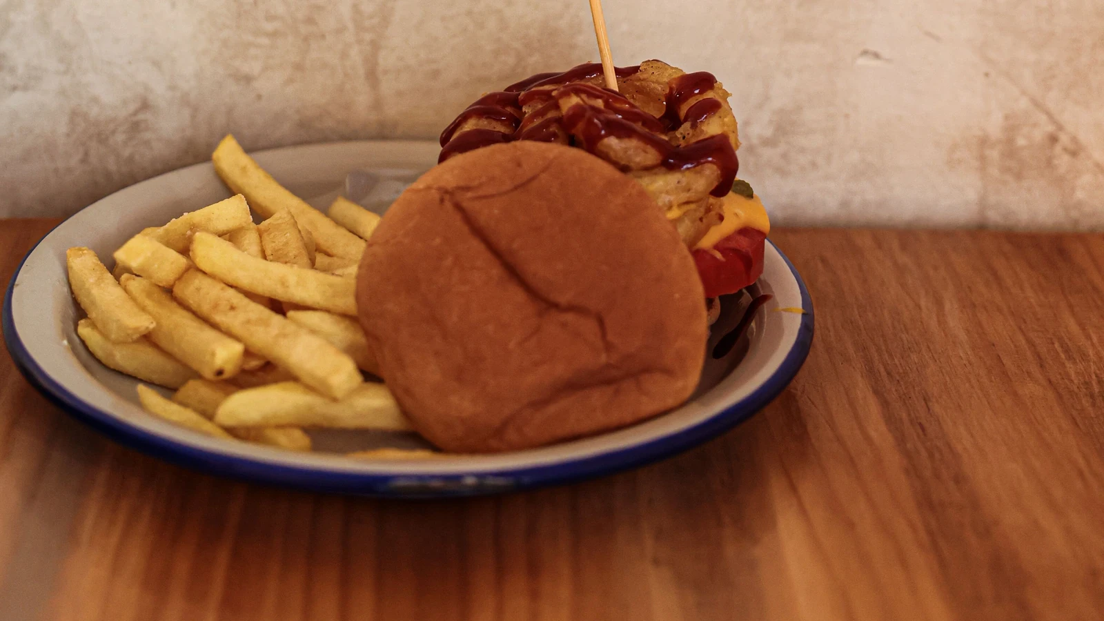 A vegan burger and fries sit on a plate, a representative food stock photograph by Cup of Couple via Pexels.