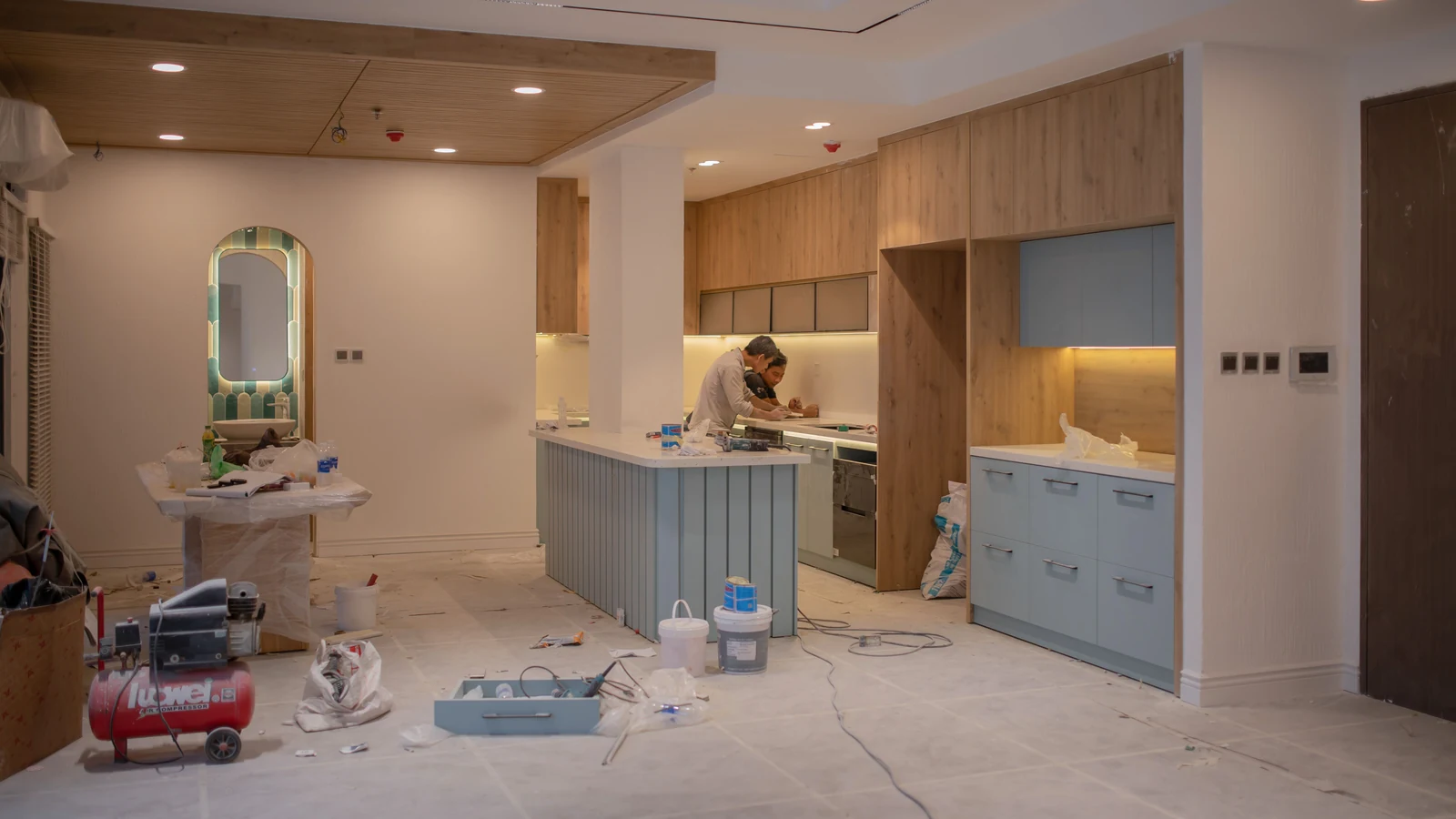 Workers in a kitchen undergoing renovation, photographed by Thới Nam Cao for Pexels.