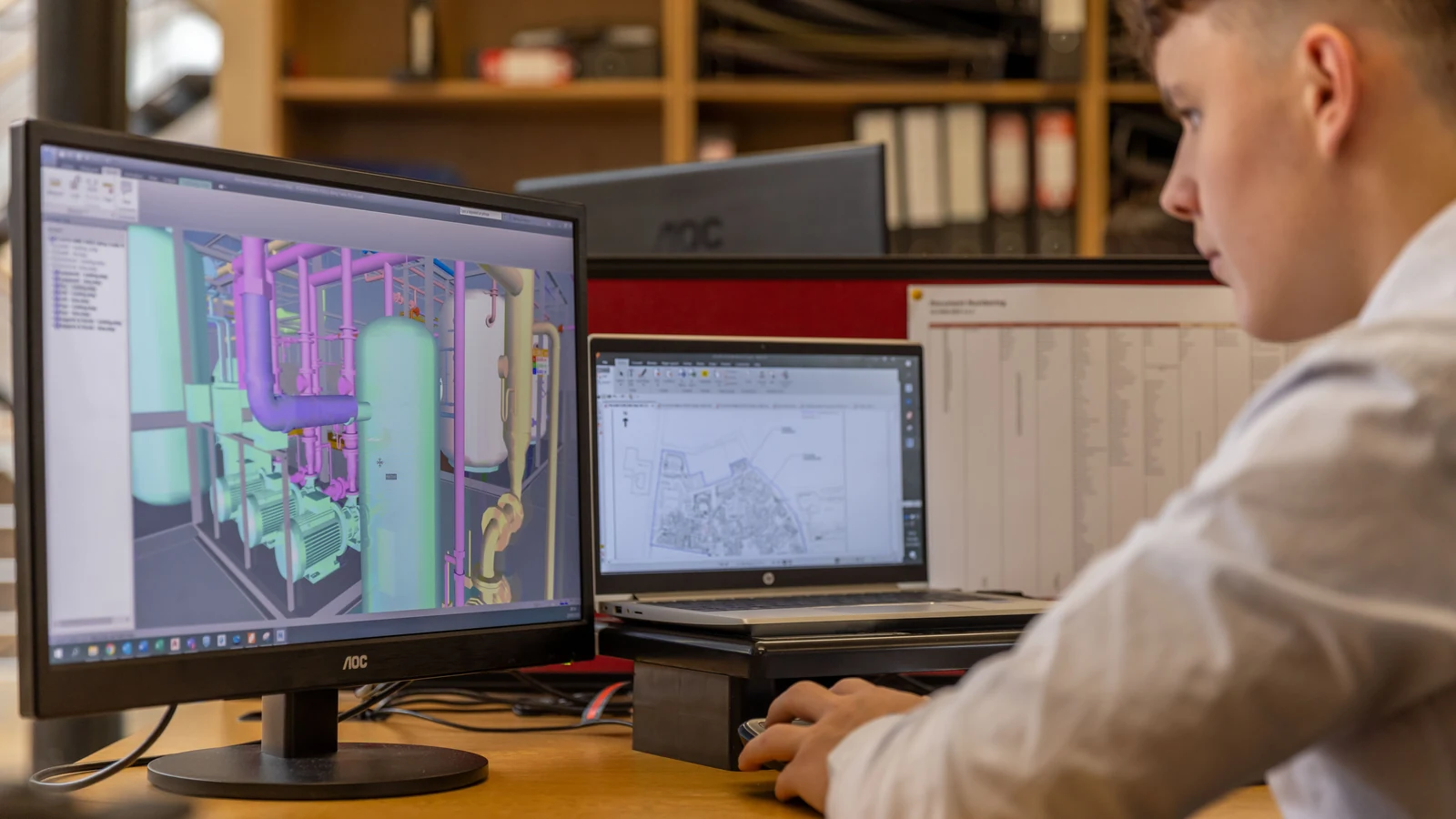 Engineer using computer monitors in an office. Representative photograph by ThisIsEngineering via Pexels.