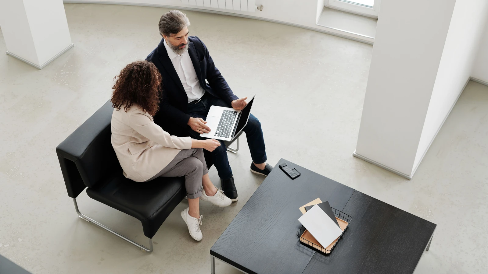 Two people discussing a laptop in an office, representative stock photography by Edmond Dantès from Pexels under the Pexels License.