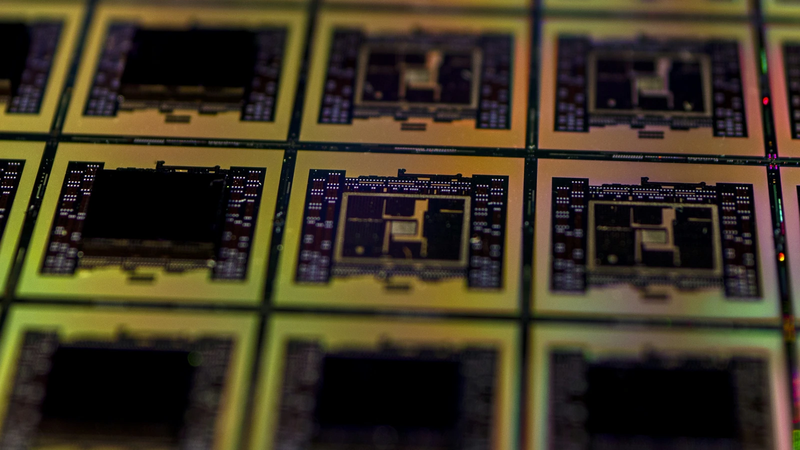 Close-up of patterned silicon wafer circuitry, a representative semiconductor photograph by Maxence Pira/Unsplash, not identified as a TSMC product.