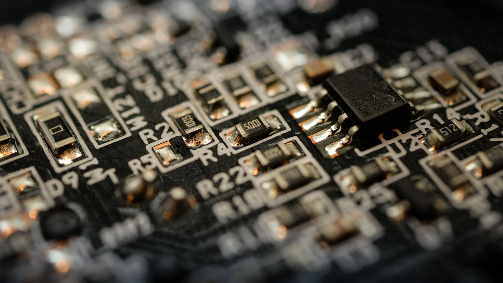 Close-up of chips and components on a circuit board, representing electronics supply chains rather than a particular manufacturing facility; photograph by ClickerHappy/Pexels.