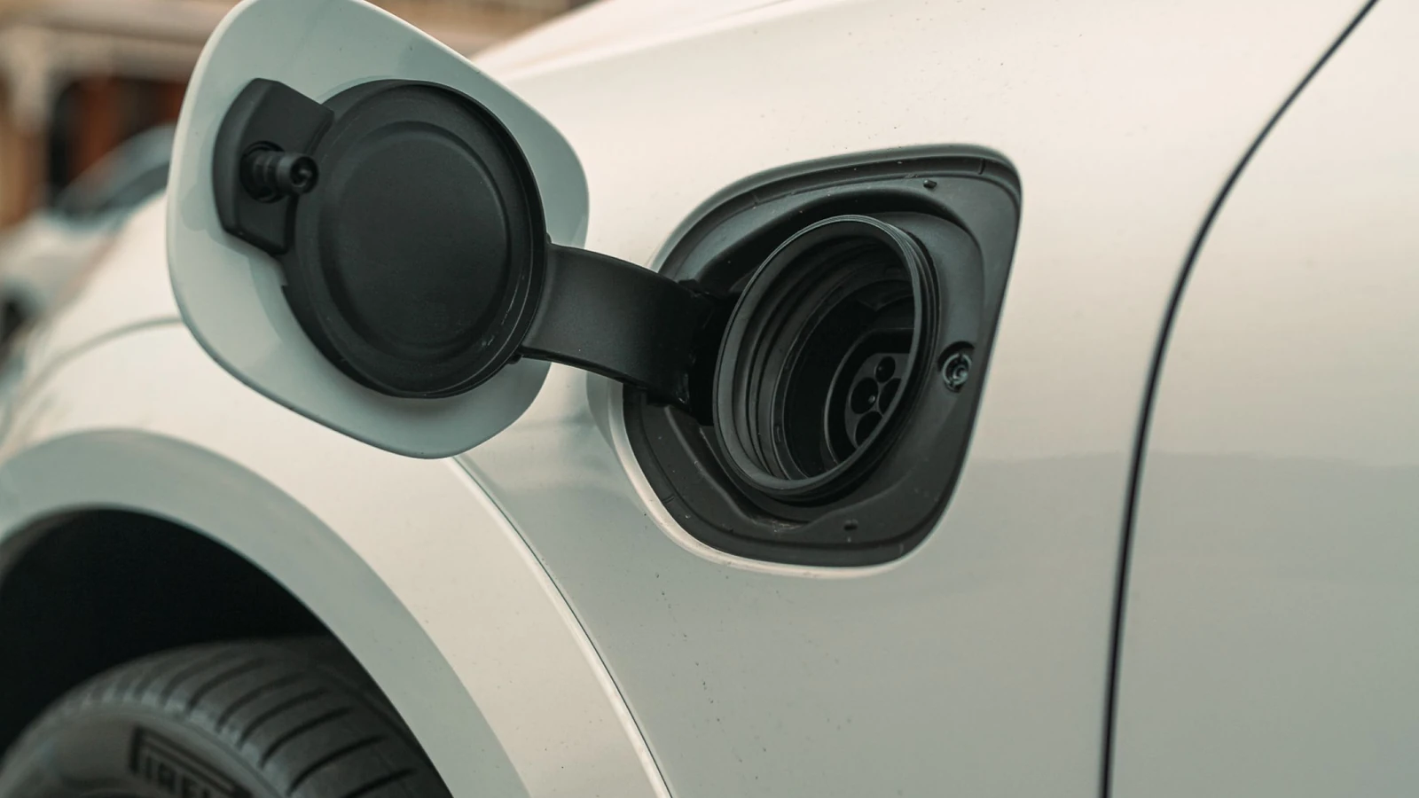 An electric car with its charging port open, a representative stock photograph by Matt Jerome Connor via Pexels.